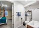 Modern bathroom with sleek fixtures, decorative shelf, and tiled floors at 1742 S Alcott St, Denver, CO 80219