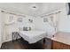 Bright bedroom featuring hardwood floors, sunlit windows with curtains and minimalist decor at 1742 S Alcott St, Denver, CO 80219