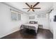 Cozy bedroom featuring a comfortable bed, ceiling fan, and natural light from two bright windows at 1742 S Alcott St, Denver, CO 80219