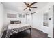 Comfortable bedroom featuring a decorative barn door, ceiling fan and two sunlit windows at 1742 S Alcott St, Denver, CO 80219