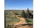 Scenic view of the Ruby Hill Bike Park, showcasing dirt tracks, trees, and the Denver skyline at 1742 S Alcott St, Denver, CO 80219