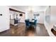 Dining room with wood floors, designer lighting, table and chairs, open to living room with kitchen beyond at 1742 S Alcott St, Denver, CO 80219