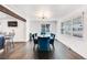 Dining room featuring wood floors, designer lighting, blue chairs and access to the kitchen at 1742 S Alcott St, Denver, CO 80219