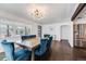 Elegant dining room featuring wood floors, designer lighting, and a stylish dining table with blue chairs at 1742 S Alcott St, Denver, CO 80219