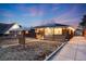 Charming home with solar panels, brick facade, front porch with decorative wood and long driveway at 1742 S Alcott St, Denver, CO 80219