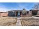 Updated home showcasing solar panels, brick facade, front porch with decorative wood, and walkway at 1742 S Alcott St, Denver, CO 80219