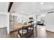 Bright kitchen features white cabinets, stainless appliances and a large center island with barstool seating at 1742 S Alcott St, Denver, CO 80219
