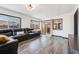 Bright living room features a sectional sofa, hardwood flooring, and sliding glass doors to the outside at 1742 S Alcott St, Denver, CO 80219