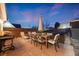 Outdoor patio featuring dining set, grill, and ample space for entertaining under the dusk sky at 1742 S Alcott St, Denver, CO 80219