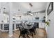 Modern kitchen with white cabinets, island seating, and dining area at 1563 E 131St Pl, Thornton, CO 80241