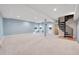 Large basement with carpeted floors and spiral staircase at 9128 Hillview Rd, Morrison, CO 80465