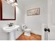 Clean bathroom with pedestal sink, toilet, and terracotta floor at 9128 Hillview Rd, Morrison, CO 80465