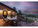 Deck with patio furniture and mountain views at sunset at 9128 Hillview Rd, Morrison, CO 80465