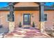 Inviting front entrance with stone columns and a charming, dark wood door at 9128 Hillview Rd, Morrison, CO 80465