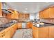 Spacious kitchen with light wood cabinets, granite countertops, and stainless steel appliances at 9128 Hillview Rd, Morrison, CO 80465