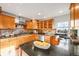 Modern kitchen with wood cabinets, granite island, and a view from the window at 9128 Hillview Rd, Morrison, CO 80465