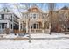 Two-story craftsman home with front porch, snowy yard at 3386 Ulster St, Denver, CO 80238