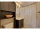 Clean bathroom with updated vanity, shower, and dark wood cabinet at 3701 W Greenwood Pl, Denver, CO 80236