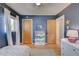 bedroom with navy walls, star decals, and bookshelf at 3701 W Greenwood Pl, Denver, CO 80236