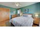 Spacious bedroom with wood floors and mid-century modern furniture at 3701 W Greenwood Pl, Denver, CO 80236