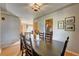 Spacious dining room with dark wood table and six chairs at 3701 W Greenwood Pl, Denver, CO 80236