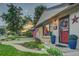 Well-maintained ranch home with a red door and lush landscaping at 3701 W Greenwood Pl, Denver, CO 80236