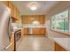 Modern kitchen with stainless steel appliances and wood cabinets at 3701 W Greenwood Pl, Denver, CO 80236