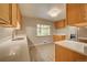 Kitchen features stainless steel appliances and wood cabinets at 3701 W Greenwood Pl, Denver, CO 80236