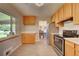 Updated kitchen with stainless steel appliances and wood cabinets at 3701 W Greenwood Pl, Denver, CO 80236