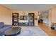 Open living room featuring built-in shelving and hardwood floors at 3701 W Greenwood Pl, Denver, CO 80236