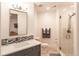 Bathroom with white marble countertop, gray vanity, glass-enclosed shower, and tile flooring at 6302 Charrington Dr, Cherry Hills Village, CO 80111