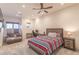 Bright bedroom with carpet, ceiling fan, window, gaming desk, and neatly made bed in neutral modern decor at 6302 Charrington Dr, Cherry Hills Village, CO 80111