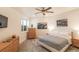 Neutrally decorated bedroom featuring gray carpet, bed, and stylish wood dressers at 6302 Charrington Dr, Cherry Hills Village, CO 80111