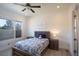 Cozy bedroom with a wooden bed frame, blue accents, and soft carpeting at 6302 Charrington Dr, Cherry Hills Village, CO 80111