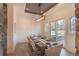 A formal dining room with modern lighting and backyard views at 6302 Charrington Dr, Cherry Hills Village, CO 80111