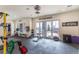 Home gym with weightlifting equipment, inspiring workout slogans, large windows and rubberized flooring at 6302 Charrington Dr, Cherry Hills Village, CO 80111