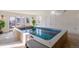 Indoor pool with blue-patterned tile, and tile flooring with lots of natural light from large glass windows at 6302 Charrington Dr, Cherry Hills Village, CO 80111