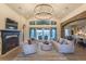 Spacious living room with fireplace, chandeliers, and floor to ceiling windows at 6302 Charrington Dr, Cherry Hills Village, CO 80111