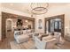 Open living room with stone archways, modern lighting, and kitchen access at 6302 Charrington Dr, Cherry Hills Village, CO 80111