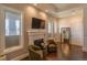 Cozy living room space with fireplace, chairs, and nice window light at 6302 Charrington Dr, Cherry Hills Village, CO 80111