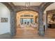 Elegant living room with stone archways, chandeliers, and mountain views at 6302 Charrington Dr, Cherry Hills Village, CO 80111