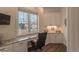 Home office space with built-in desk, cabinets, and views of the neighborhood at 6302 Charrington Dr, Cherry Hills Village, CO 80111