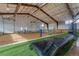 Indoor volleyball court with nets, balls, and lounge seating for spectators at 6302 Charrington Dr, Cherry Hills Village, CO 80111