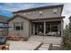 View of the back patio, covered seating area, and backyard of this beautiful home at 8010 Blue River Ave, Littleton, CO 80125