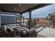 Covered back porch with comfortable wicker furniture and backyard views at 8010 Blue River Ave, Littleton, CO 80125