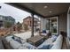 Relaxing back porch with wicker furniture and view of the backyard at 8010 Blue River Ave, Littleton, CO 80125