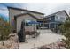 Backyard includes a patio set, grill and landscaped features at 8010 Blue River Ave, Littleton, CO 80125