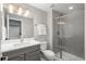 Modern bathroom with white vanity top, gray cabinets, and a glass-enclosed walk-in shower at 8010 Blue River Ave, Littleton, CO 80125