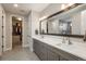 Elegant bathroom features a dual sink vanity, large mirror, and a luxurious walk-in closet and shower at 8010 Blue River Ave, Littleton, CO 80125