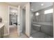 Beautiful bathroom with large tiled shower, built in bench, and open access to the main bedroom at 8010 Blue River Ave, Littleton, CO 80125